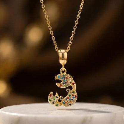 gold crab pendant necklace with colorful stones on marble background luxury jewelry
