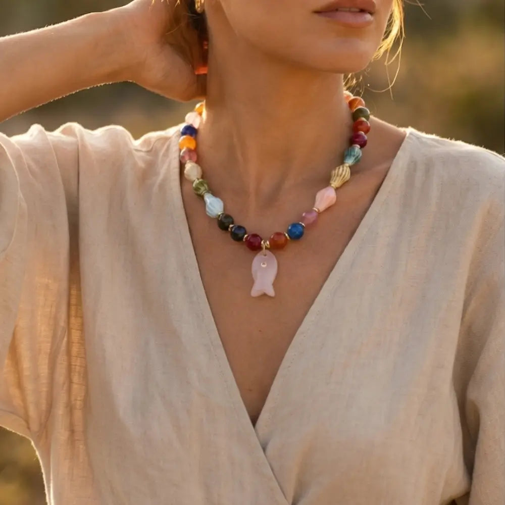 Woman wearing colorful gemstone fish necklace handmade beaded jewelry Julie Saldivia