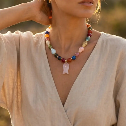 Woman wearing colorful gemstone fish necklace handmade beaded jewelry Julie Saldivia
