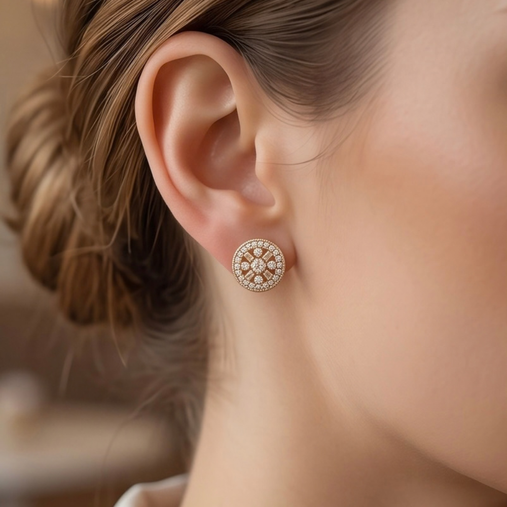 Model wearing an Éclat circular gold-tone stud earring with sparkling clear accents.