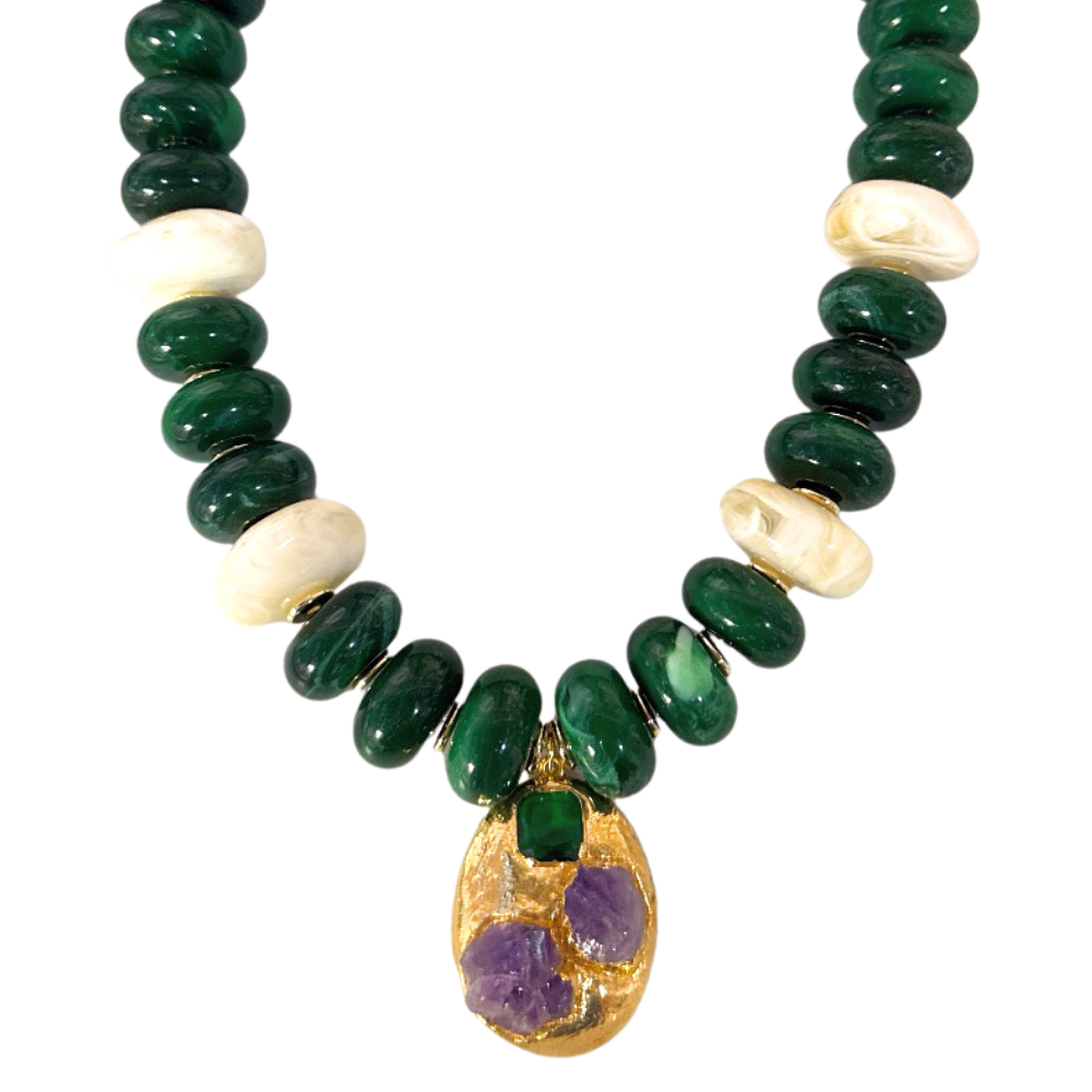 Close-up of woman wearing Emerald Relic Necklace with deep green and marbled off-white acrylic beads and gold-tone green and purple pendant