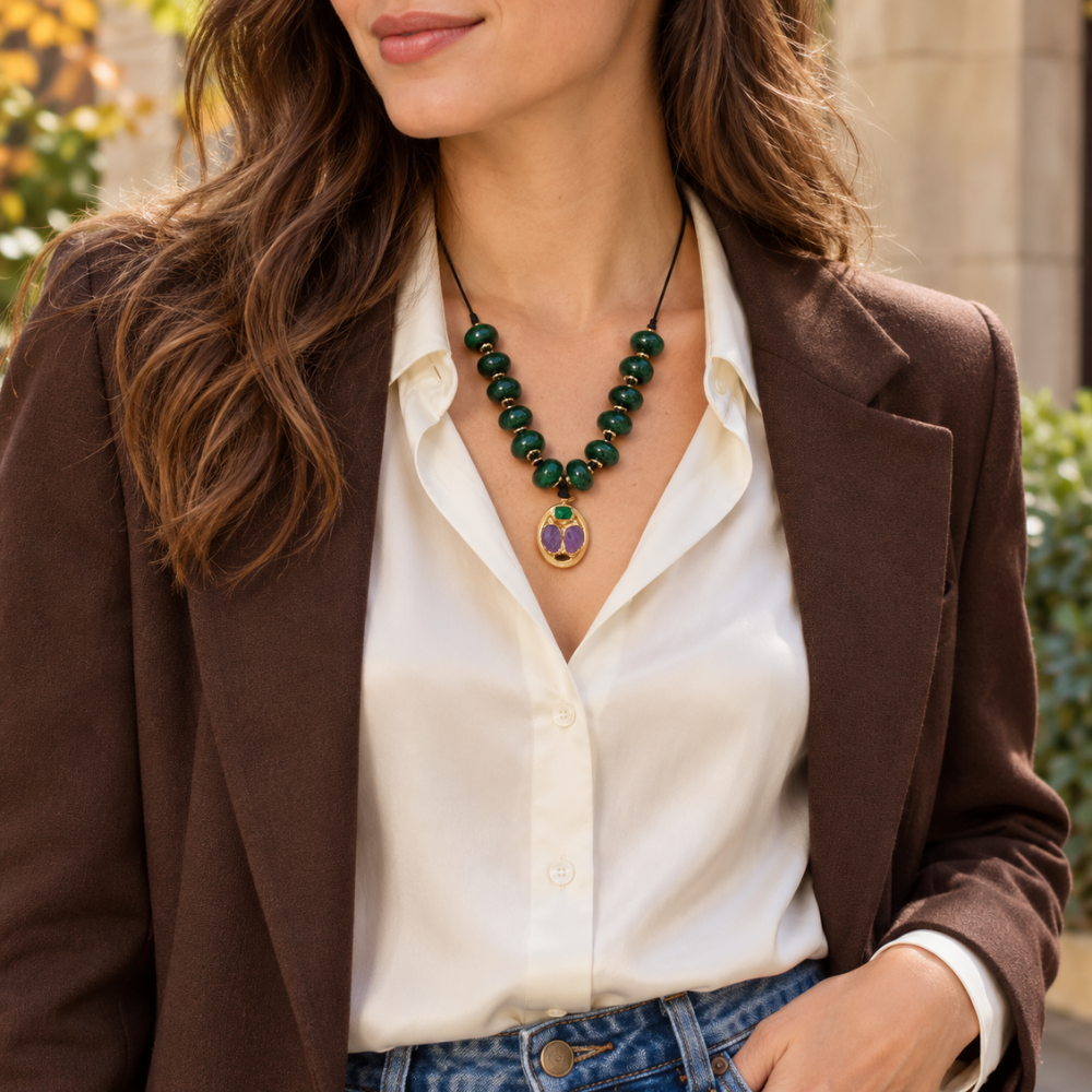 Woman wearing the Emerald Relics Cord Necklace with a white shirt, brown blazer and jeans.