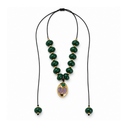 Emerald-green acrylic bead necklace on an adjustable black cord with a brass pendant and green beaded ends.
