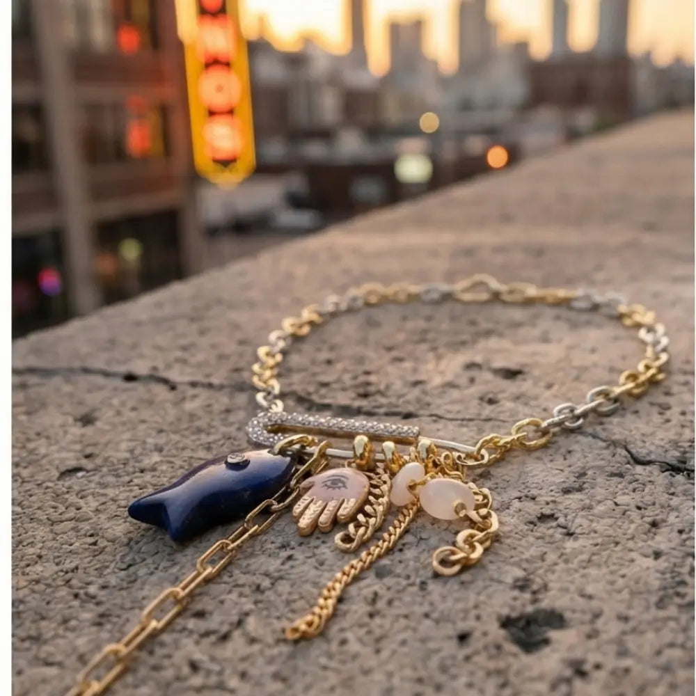 evil eye hamsa lapis charm necklace gold chain street style woman leather jacket night city