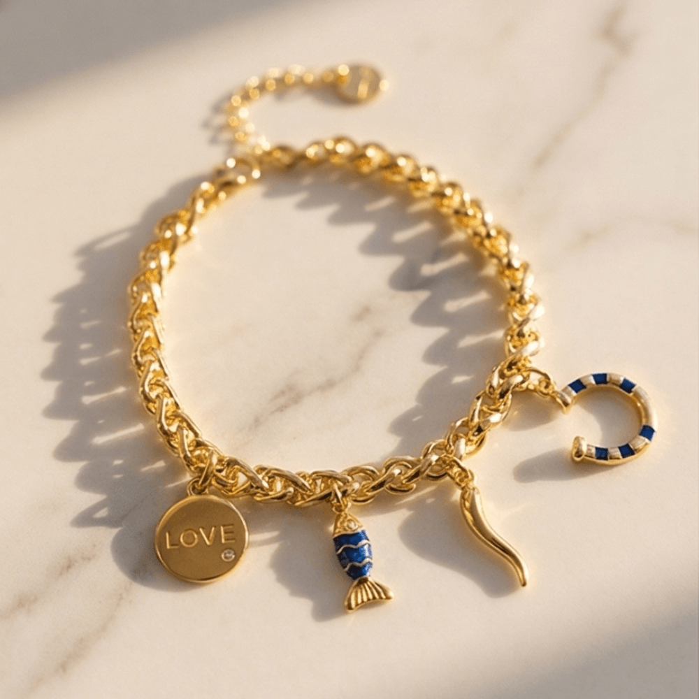 Gold chain charm bracelet with love pendant, blue fish charm and horn charm for women by Julie Saldivia Jewelry