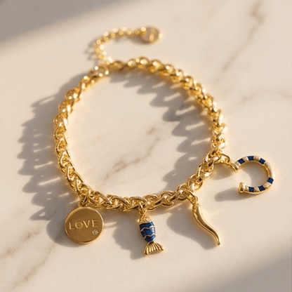 Gold chain charm bracelet with love pendant, blue fish charm and horn charm for women by Julie Saldivia Jewelry
