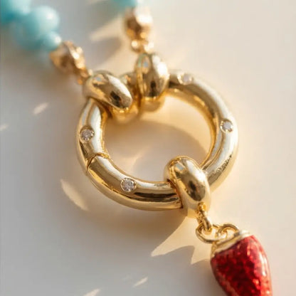 gold clasp necklace detail with red charm turquoise beads luxury jewelry Julie Saldivia