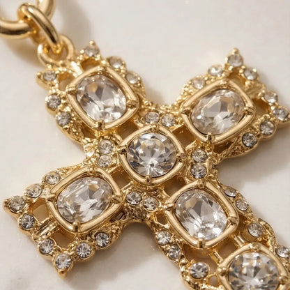 Gold cross pendant necklace with crystal stones detail close up, elegant religious jewelry for women Julie Saldivia