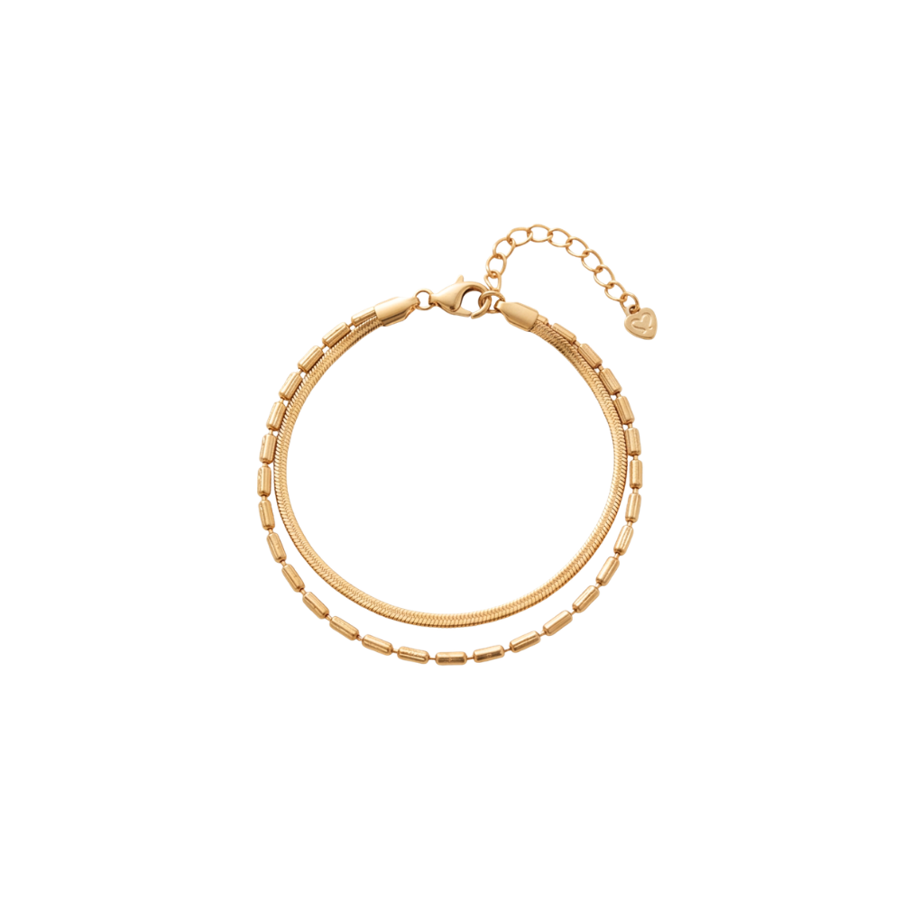 A gold-toned double-strand chain bracelet with a textured outer chain, a smoother inner chain, a lobster clasp, and an extender chain with a small heart-shaped tag, shown on a plain white background.