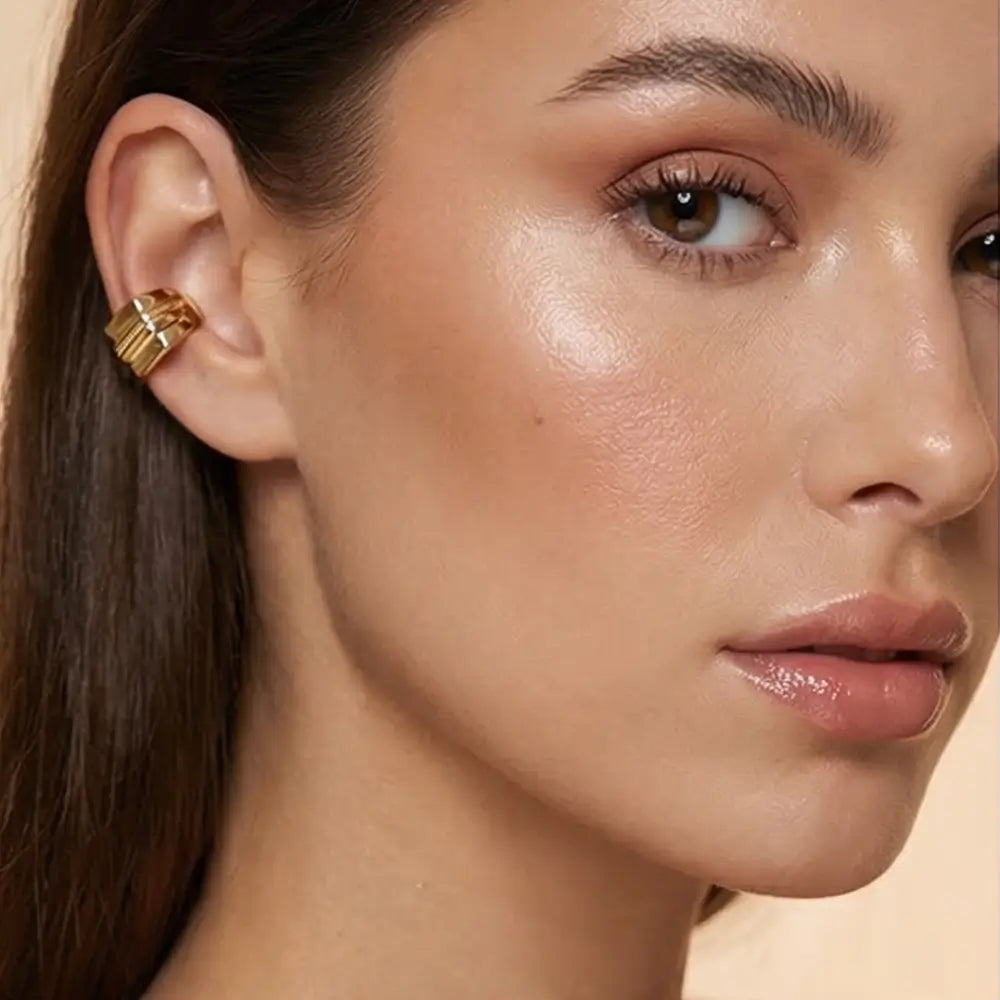 gold ear cuff no piercing worn by woman minimalist modern jewelry Julie Saldivia