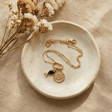 gold charm necklace with fish pendant and ship wheel charm, 18k gold plated delicate chain flat lay minimalist jewelry