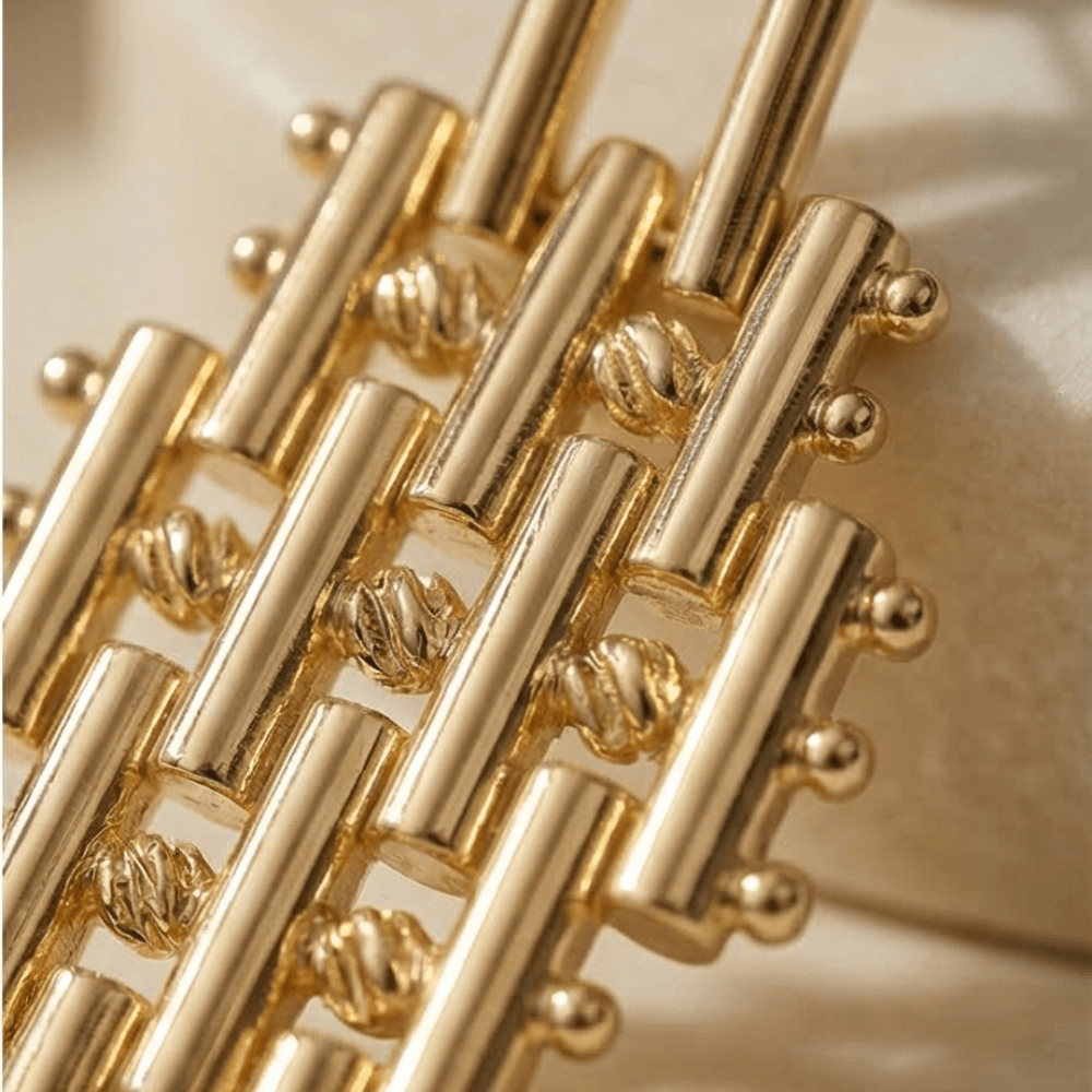 gold statement earrings close up textured geometric design luxury handmade jewelry detail