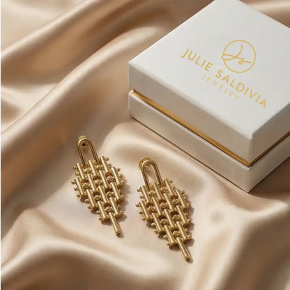 gold geometric statement earrings flat lay with julie saldivia jewelry box luxury handmade earrings
