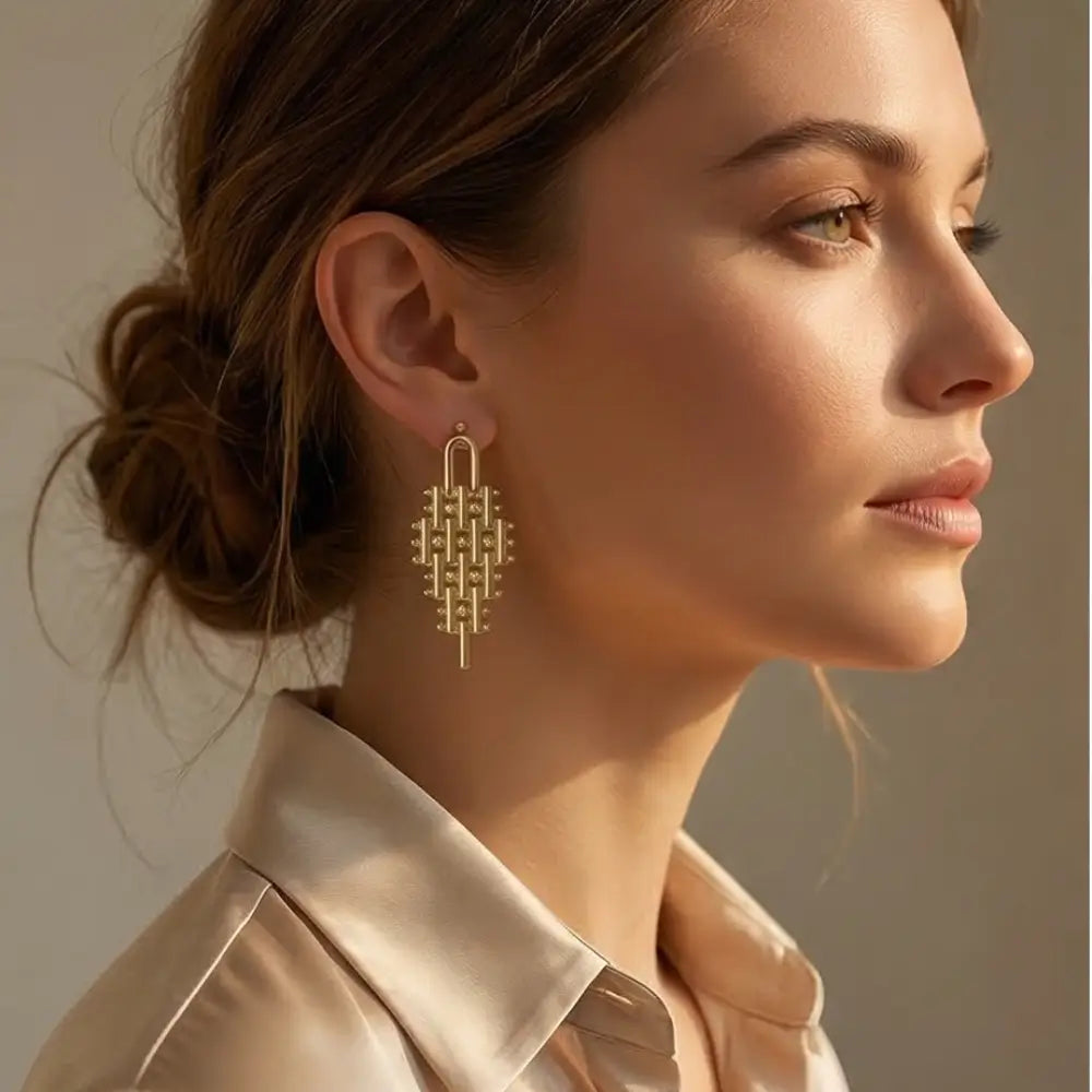 gold geometric statement earrings on woman elegant luxury handmade jewelry modern drop earrings