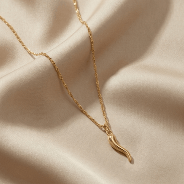 Minimalist 18k gold plated Italian horn necklace on neutral fabric