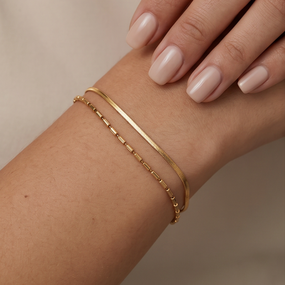 Gold layered bracelet with snake chain and beaded chain worn on wrist
