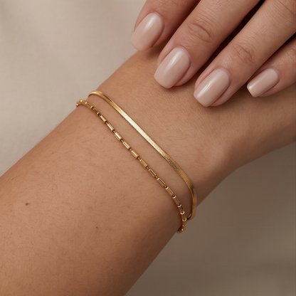 Gold layered bracelet with snake chain and beaded chain worn on wrist