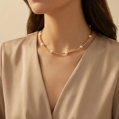 Pearl necklace worn by a model against a neutral background