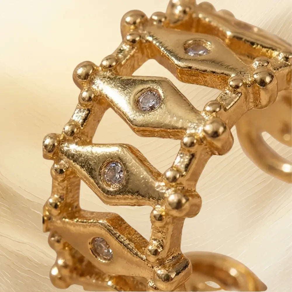 close up textured gold ear cuff with crystal details geometric statement jewelry