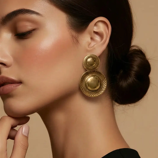 gold vintage textured disc statement earrings on woman bold elegant luxury jewelry