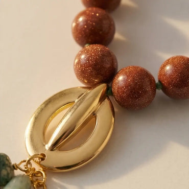 Goldstone beaded necklace with gold pendant detail handmade jewelry Julie Saldivia