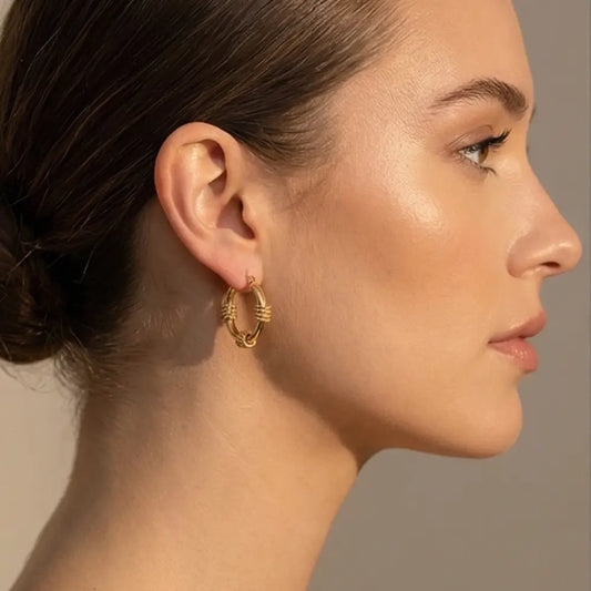 woman wearing gold hoop earrings with textured detail 18k gold plated elegant everyday jewelry