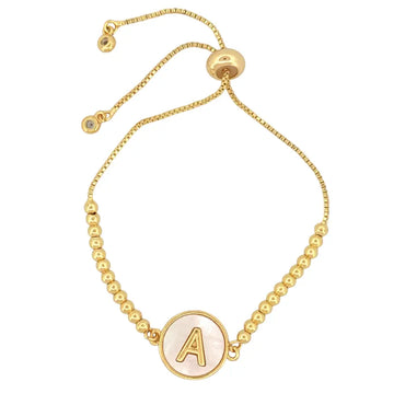 Adjustable gold mother of pearl initial bracelet with sliding clasp and personalized letter charm