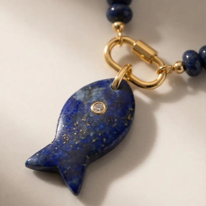 lapis lazuli fish pendant necklace with gold clasp detail close up natural stone