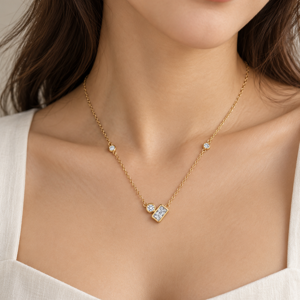 Model wearing the Lumière Bezel Necklace in gold plated 925 sterling silver with clear bezel-set stones