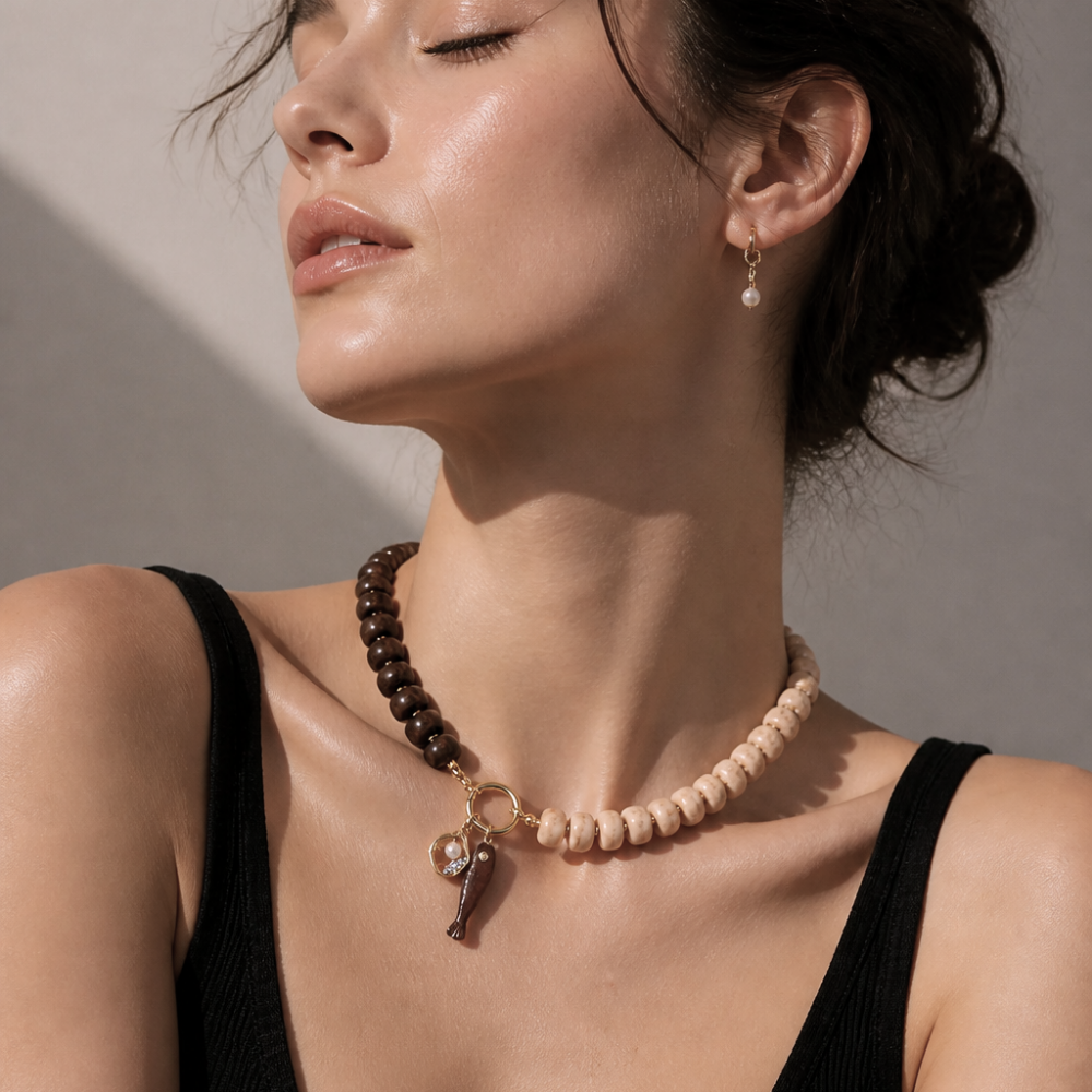 Model wearing the Marée 17-inch two-tone fish charm necklace by Julie Saldivia