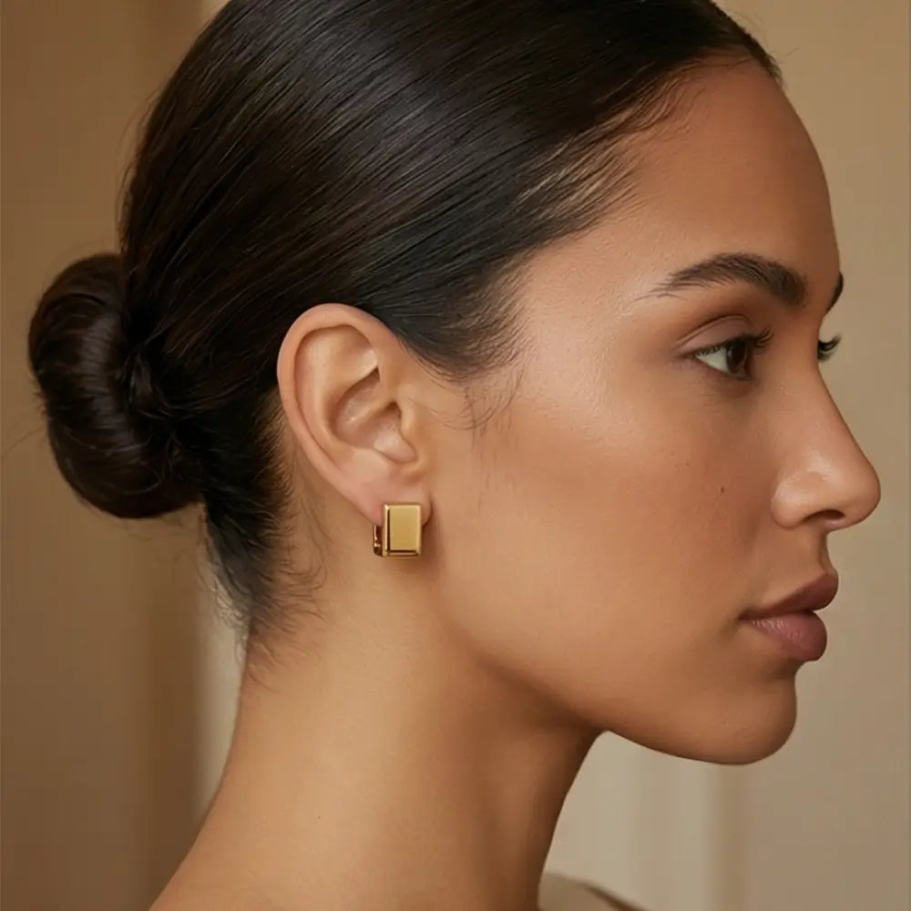 minimal gold rectangular huggie earrings worn by woman modern elegant look