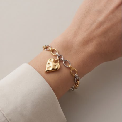Model wearing a lightweight two-tone bracelet with textured heart charm by Julie Saldivia