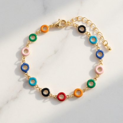 Colorful bracelet with gold chain on a light background