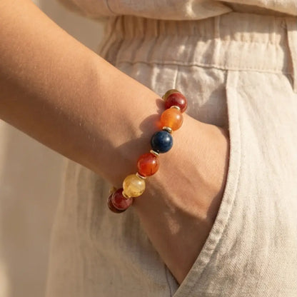 woman wearing multicolor gemstone bracelet with gold details elegant everyday jewelry