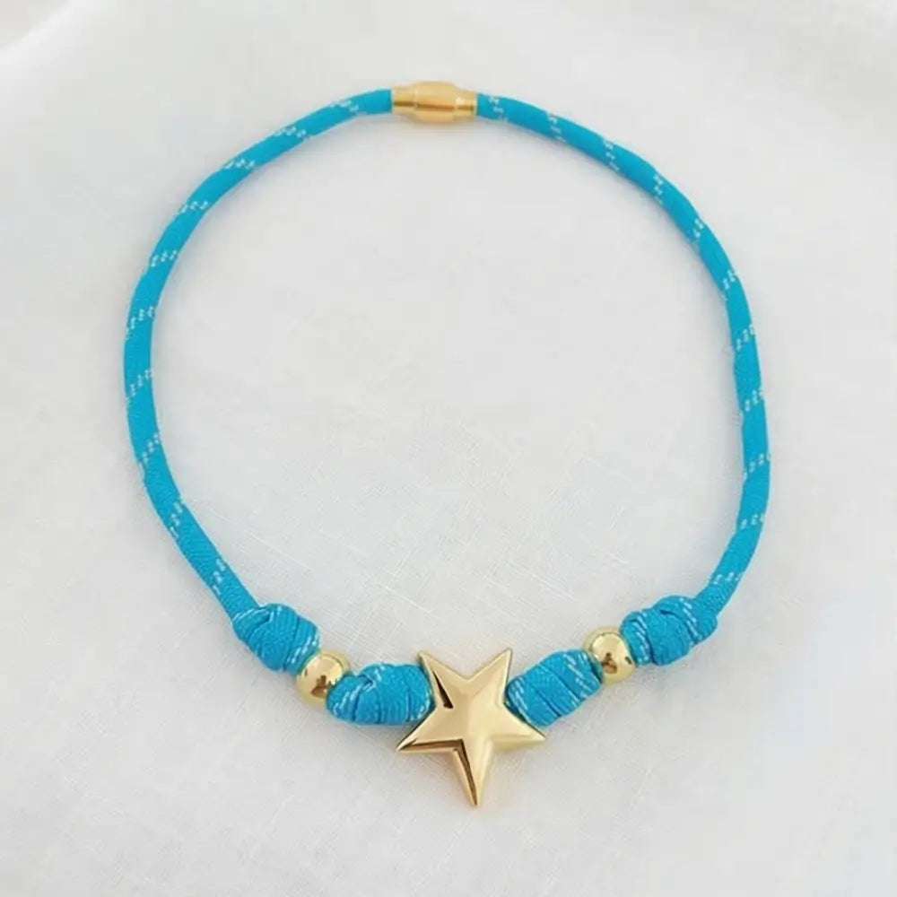 Blue necklace with a gold star pendant on a white background