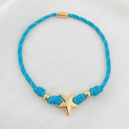 Blue necklace with a gold star pendant on a white background