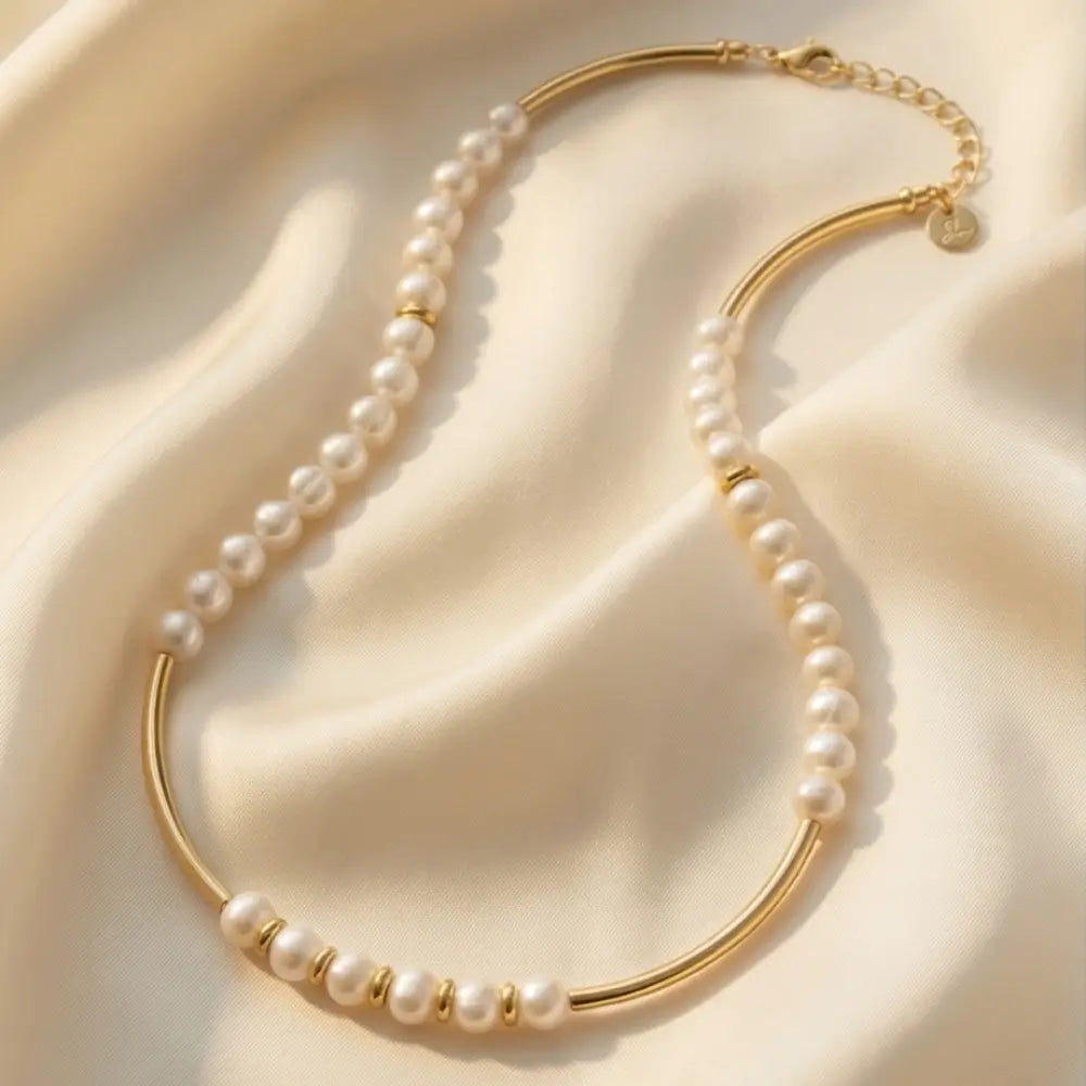 pearl necklace with gold bar accents minimalist jewelry flat lay