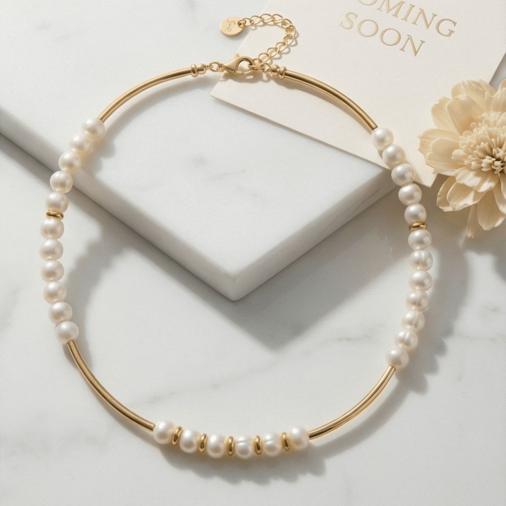 minimalist pearl necklace gold bar accents luxury jewelry styled flat lay