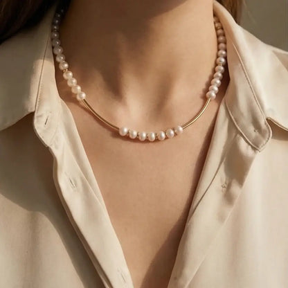 woman wearing minimalist pearl necklace with gold bar accents elegant design