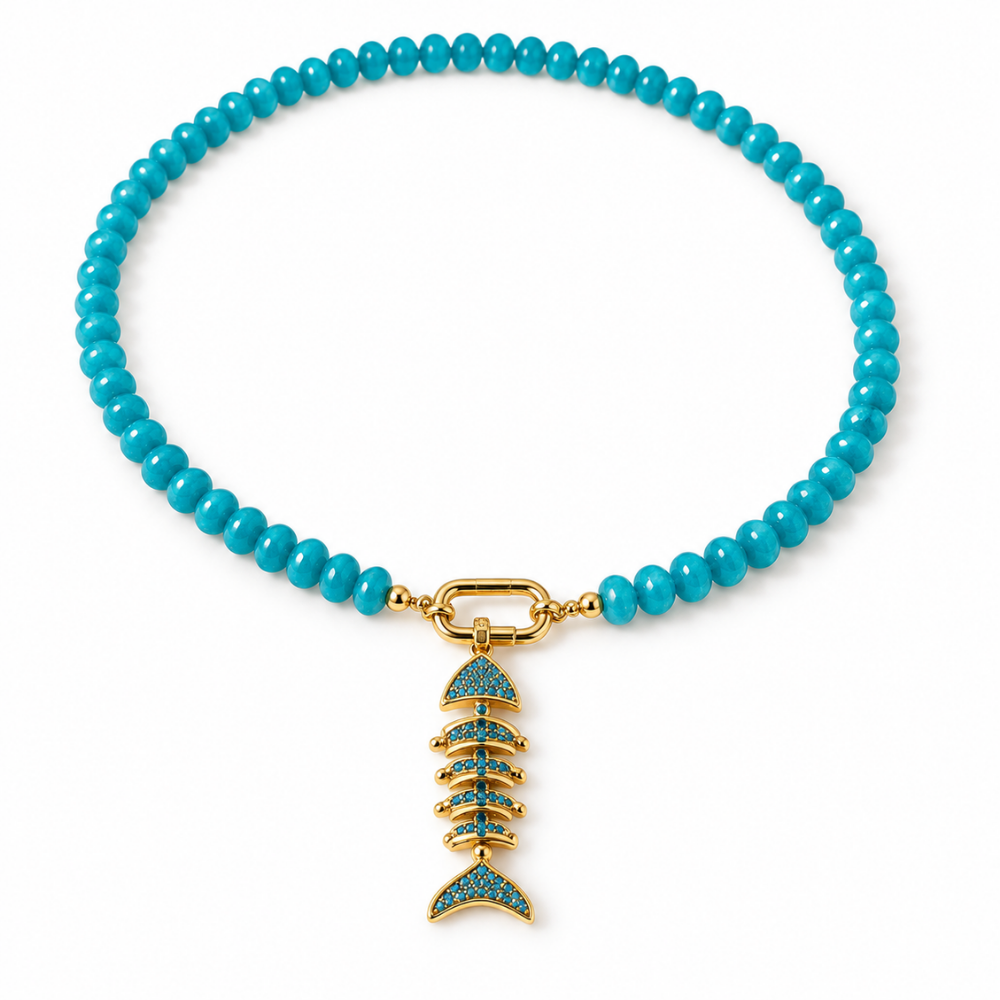 18-inch turquoise-hued aventurine necklace with an oval front clasp and an 18k gold-plated fishbone pendant with blue sparkling accents on a white background.