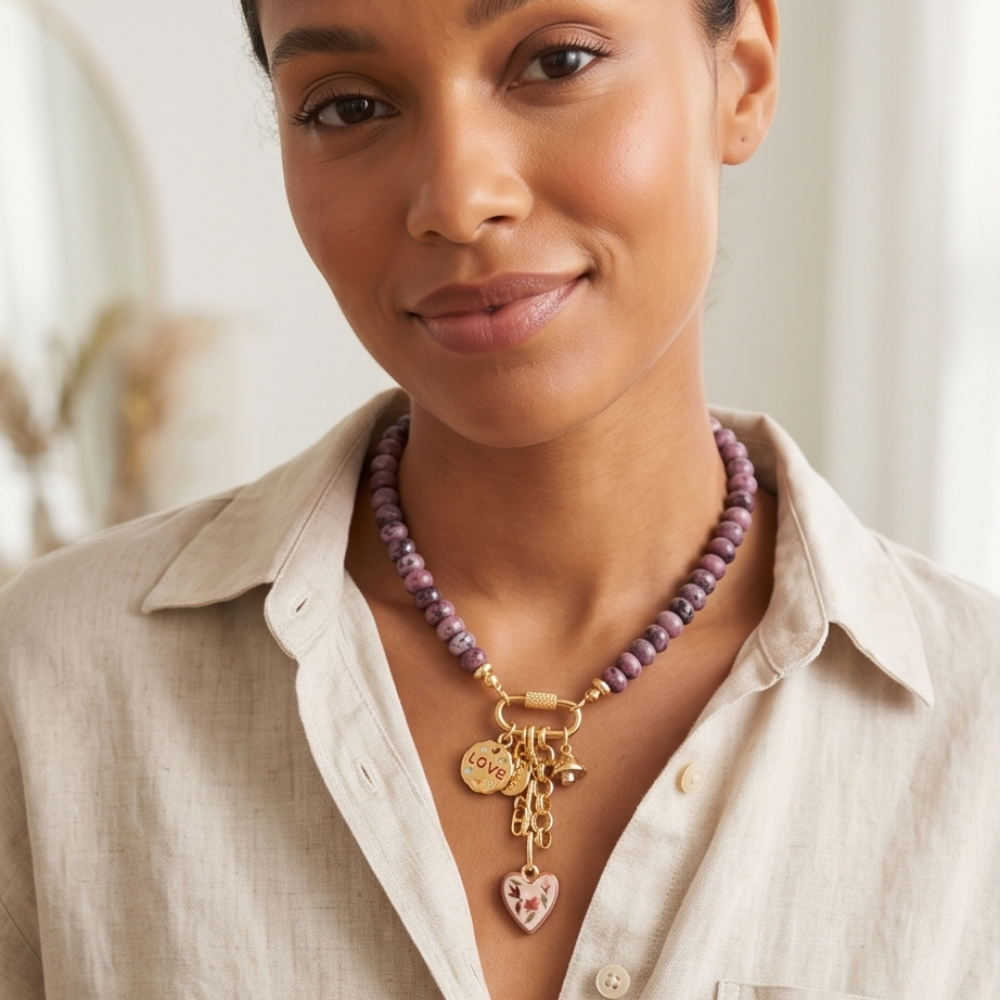 Woman wearing a purple beaded necklace with gold charms