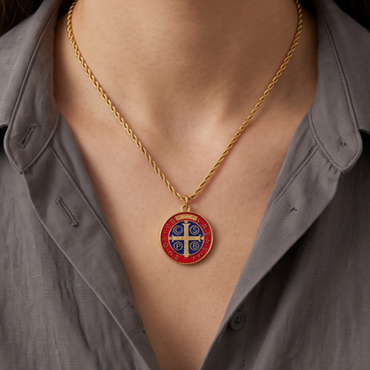 Gold Saint Benedict necklace with red and blue enamel medallion worn on model