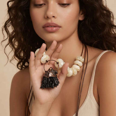 Model wearing Sienna ivory bead sculptural pendant necklace from the Modern Relics collection