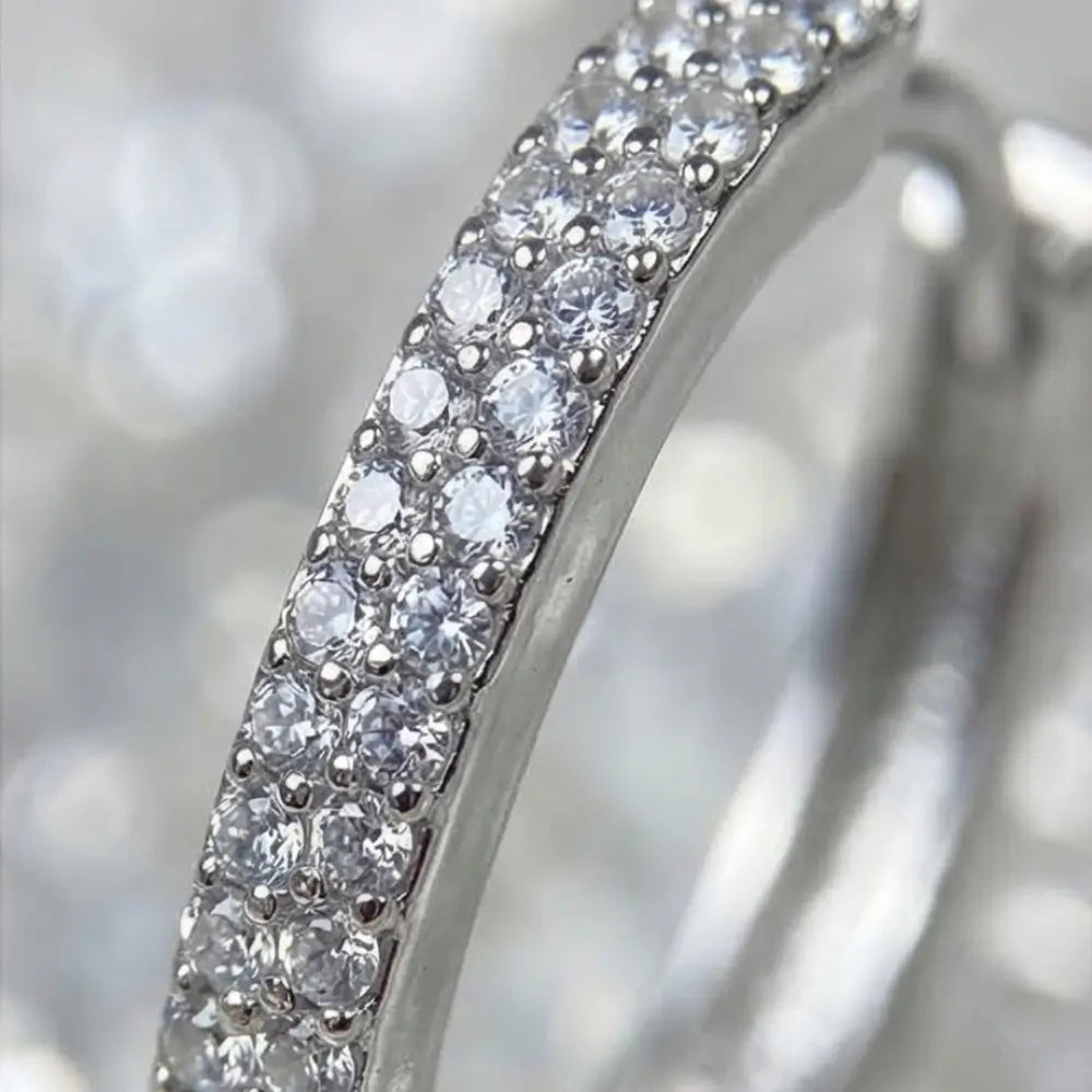 close up silver hoop earrings with cubic zirconia pave detail sparkling elegant jewelry