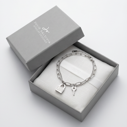 Silver bracelet with charms in a gray box, featuring the brand 'Julie Saldiva'.