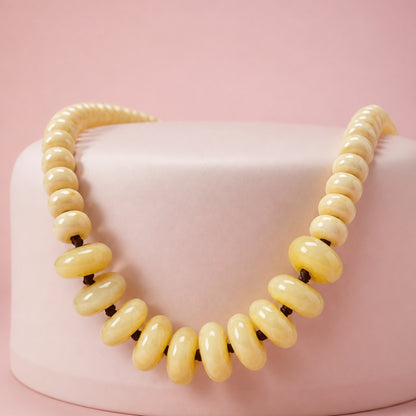 Solene adjustable necklace with high-quality 15 mm and 10 mm ivory acrylic donut beads woven on dark cord
