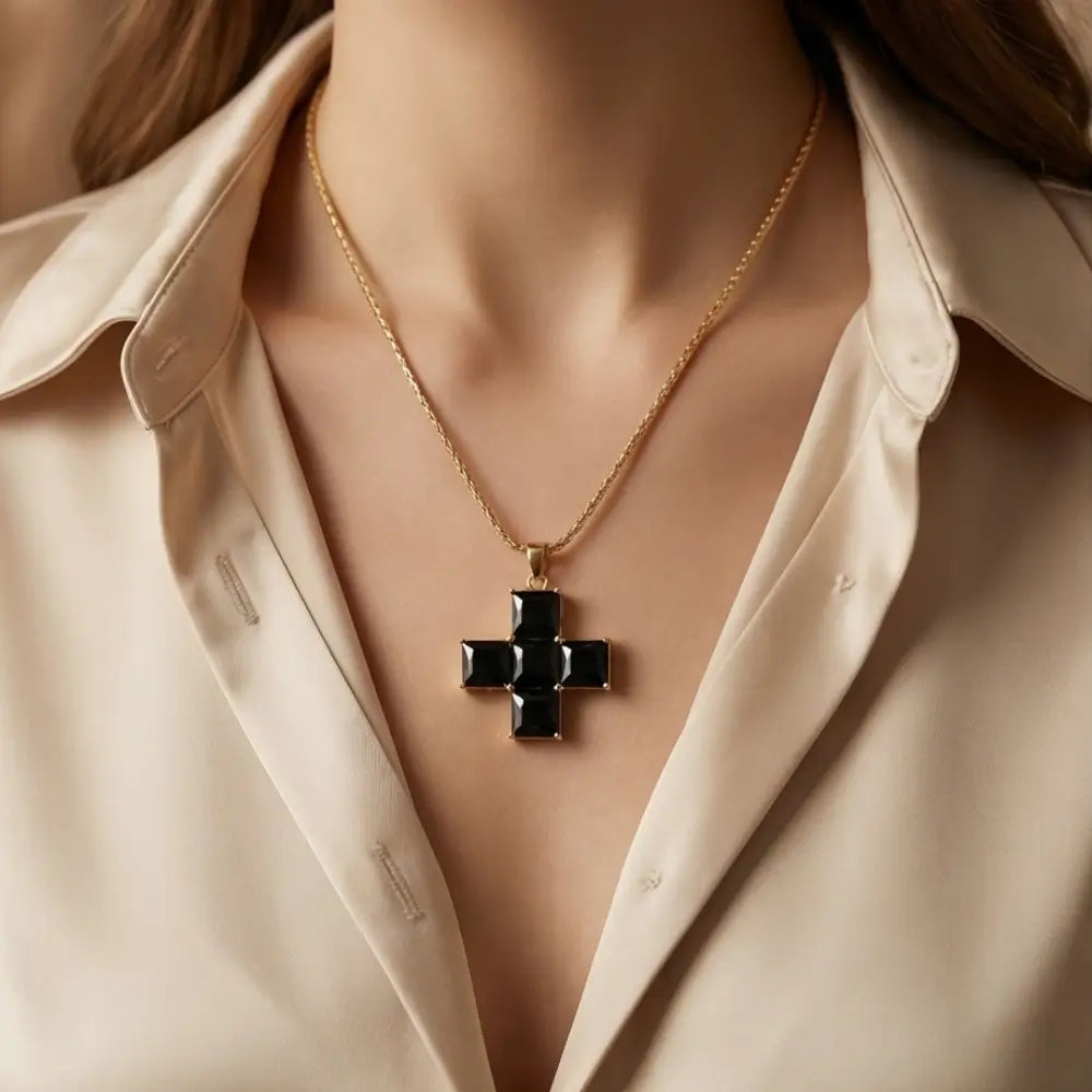 black statement cross necklace worn by woman white blouse elegant look