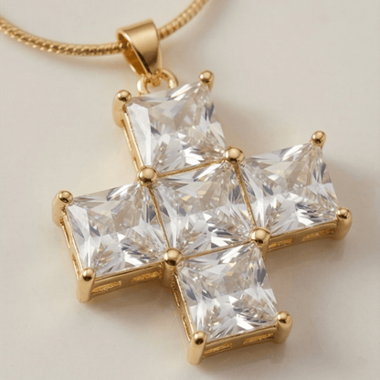 Gold necklace with a star-shaped pendant featuring clear gemstones on a light background