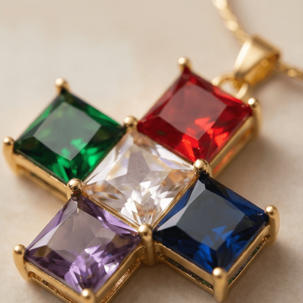 Multicolored gemstone pendant with gold setting on a light background