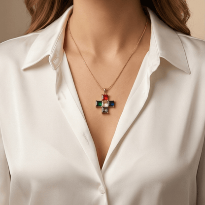 Necklace with a colorful pendant worn by a person in a white shirt.